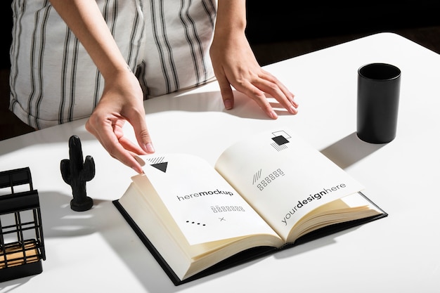 high angle of woman using book at desk