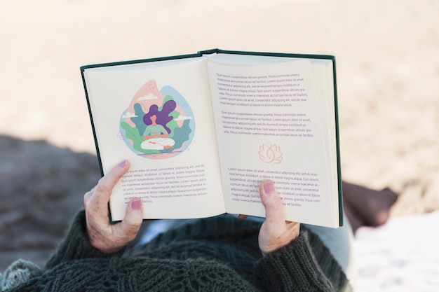 PSD high view elderly woman reading a book