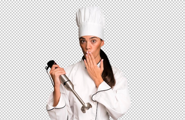 PSD hispanic pretty young adult and expressive woman chef concept and hand blender