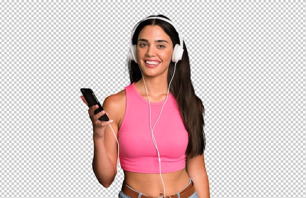 Hispanic pretty young adult and expressive woman listening music and dancing with headphones