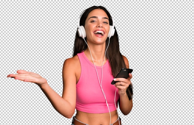 Hispanic pretty young adult and expressive woman listening music and dancing with headphones