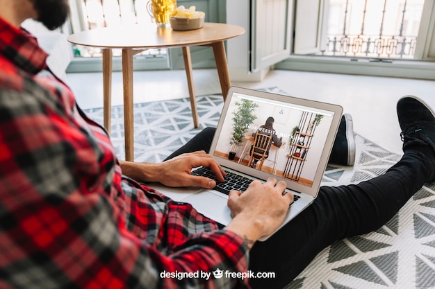 PSD home office concept with man on floor using laptop