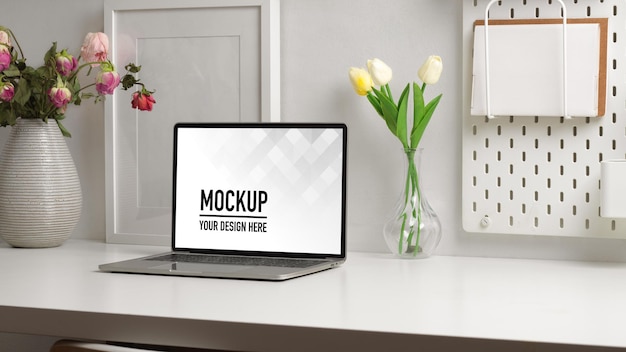 Home office desk with laptop mockup and flower vase