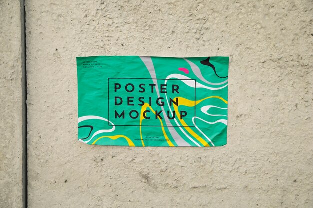 Horizontal poster mockup on wall