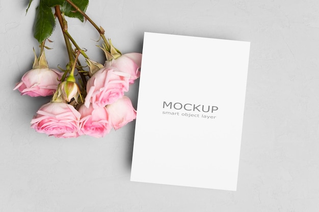 PSD invitation card mockup with flowers on grey background