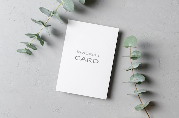 Invitation flyer or card mockup with fresh eucalyptus twigs