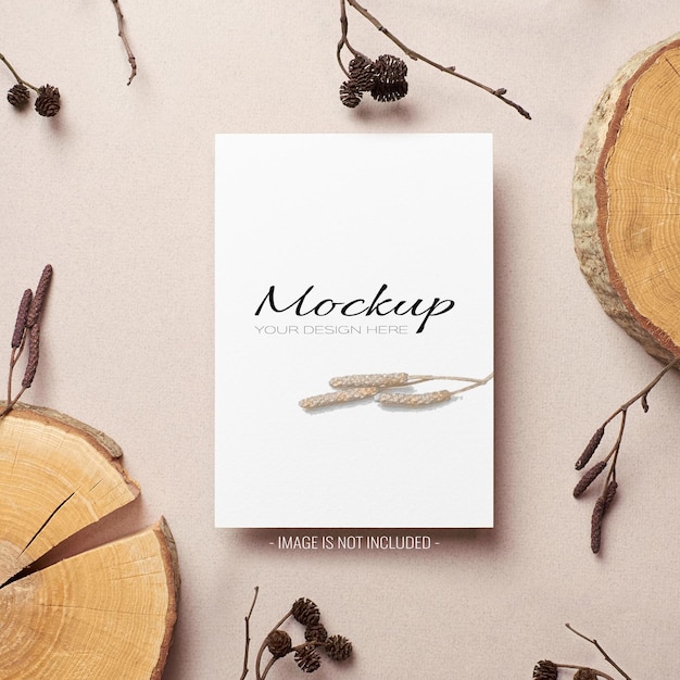 Invitation or flyer card sationary mockup with dry tree twigs and cut log decorations