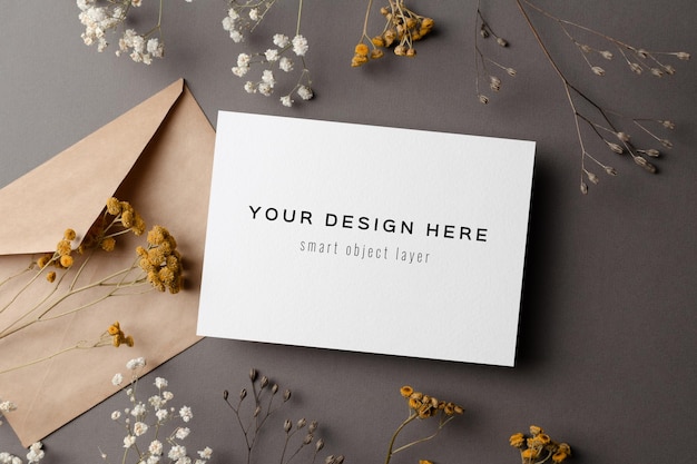 Invitation or greeting card mockup with dry flowers twigs and envelope