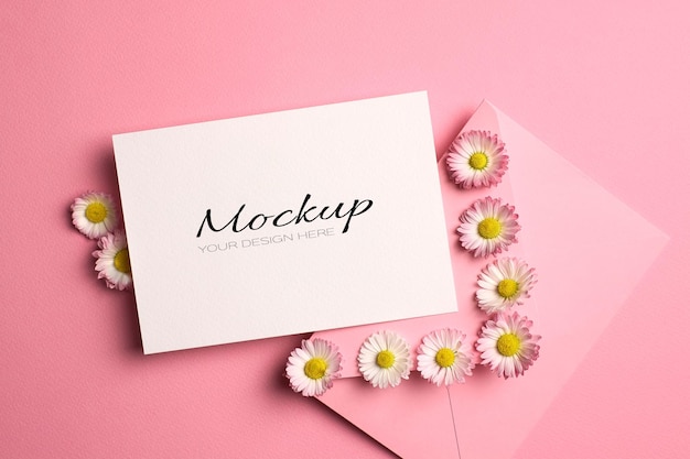 Invitation or greeting card mockup with envelope and daisy flowers on pink