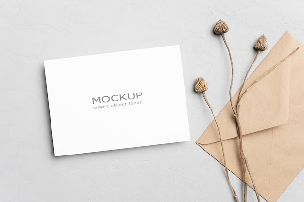 Invitation or greeting card mockup with envelope and dry plant decoration