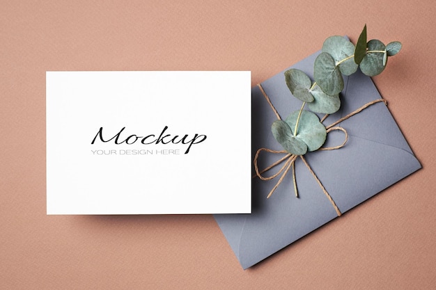 Invitation or greeting card mockup with envelope and eucalyptus twig