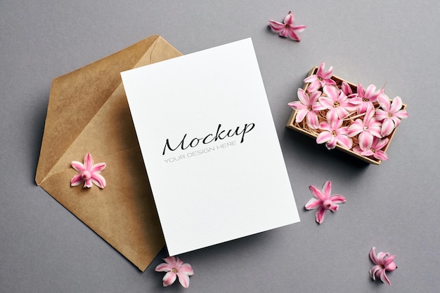 Invitation or greeting card mockup with envelope and flowers