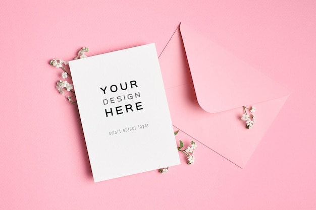 PSD invitation or greeting card mockup with envelope and forgetmenot flowers on pink