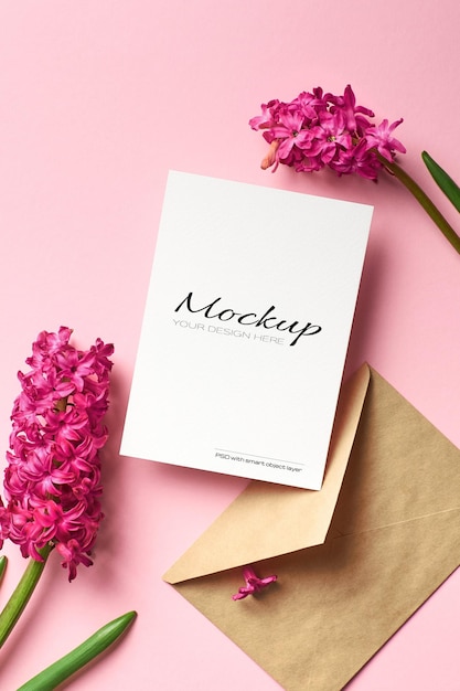 Invitation or greeting card mockup with envelope and hyacinth flowers on pink