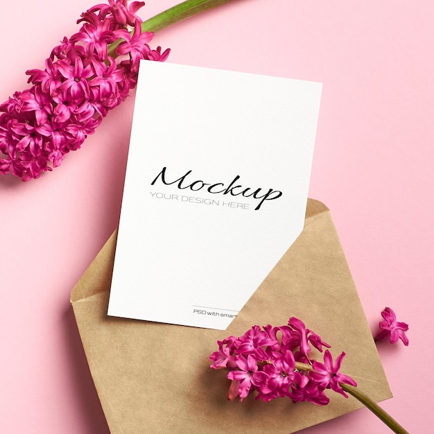 Invitation or greeting card mockup with envelope and hyacinth flowers on pink