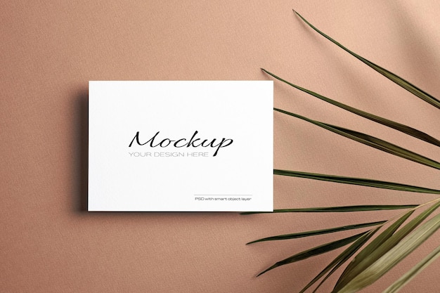 Invitation or greeting card, stationary mockup with dry nature palm leaf