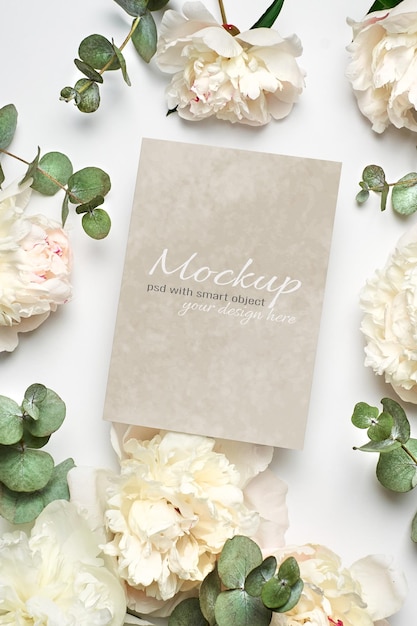 Invitation or greeting card stationary mockup with white peony flowers and eucalyptus twigs