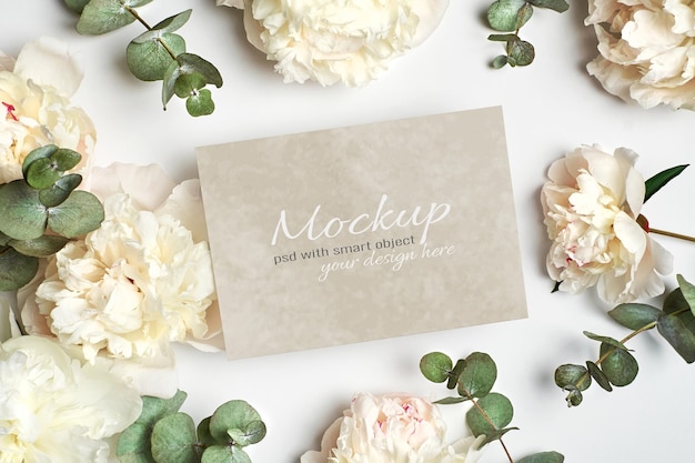 PSD invitation or greeting card stationary mockup with white peony flowers and eucalyptus twigs