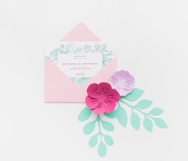 PSD invitation mock-up with paper flowers on white background