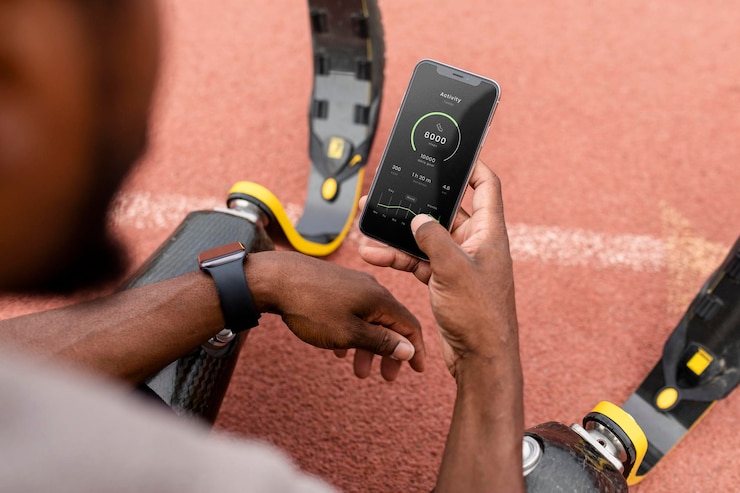 PSD iphone psd mockup with fitness tracker being held by an athlete with prosthetic legs on a running track