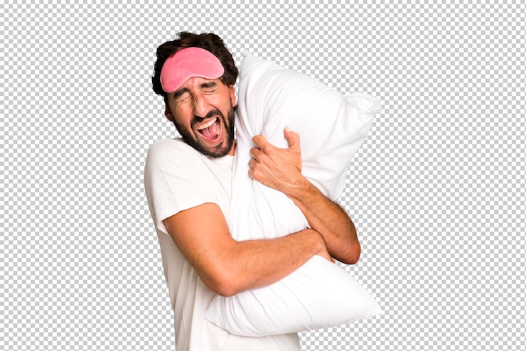 PSD jonge gekke bebaarde en expressieve man met pyjama en oogmasker en met een kussen