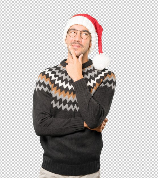 Jonge man met een kerstmuts terwijl geïsoleerd gebaren