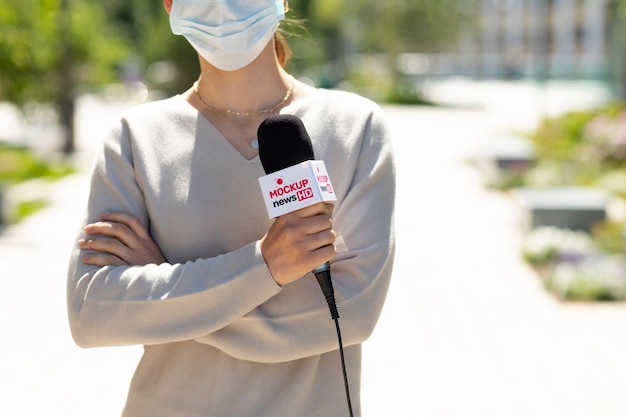 Journalist holding a microphone mockup