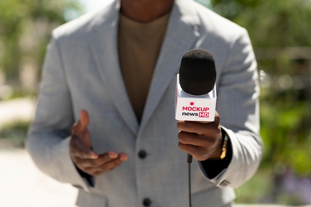 PSD journalist holding a microphone mockup