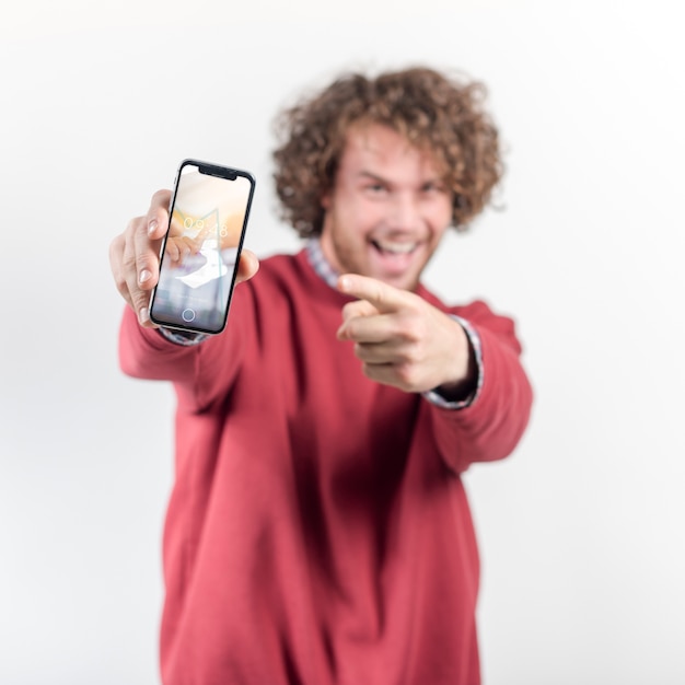 PSD joyful man holding smartphone mockup