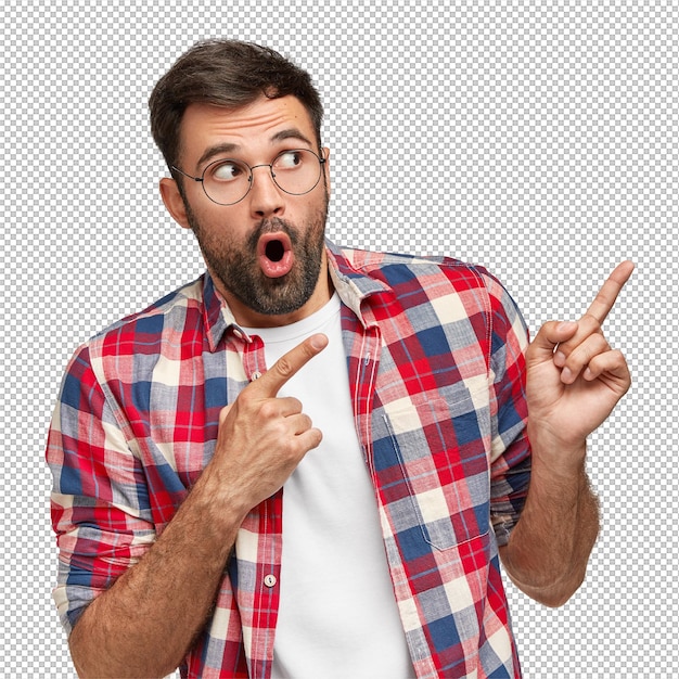 just look here vertical shot of amazed bearded man points with both index fingers at upper right corner shows something incredible dressed casually isolated over white wall pay attention to this