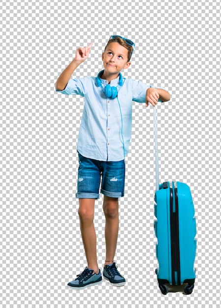 Kid with sunglasses and headphones traveling with his suitcase standing and thinking an idea