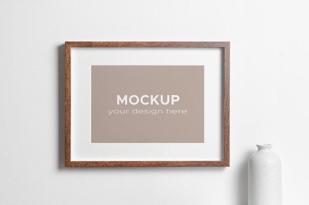 Landscape wooden frame mockup on white wall