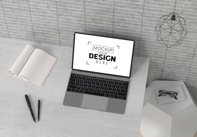 Laptop on desk in work space PSD mockup