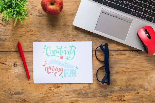 Laptop and glasses next to motivational message