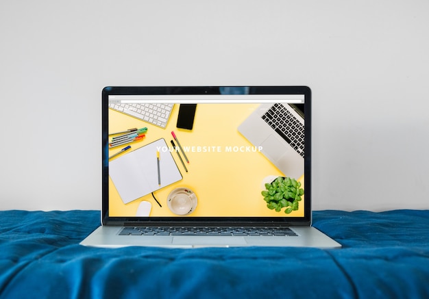 PSD laptop mockup on bed