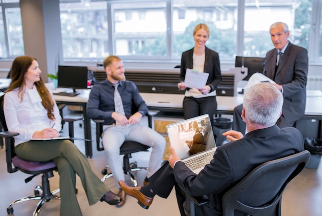 PSD laptop mockup at business meeting