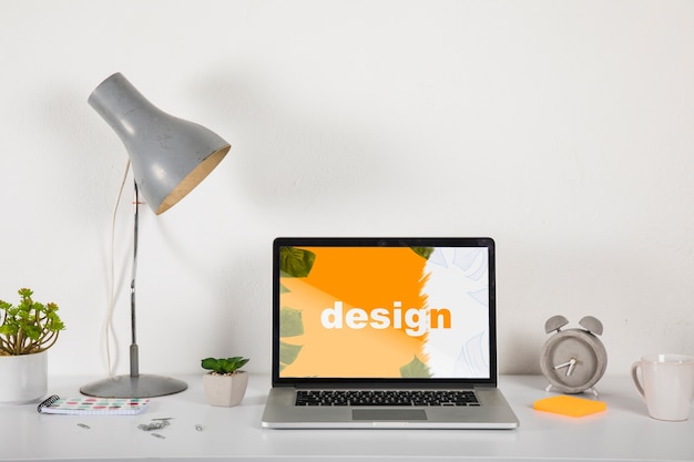 PSD laptop mockup on desk with elements