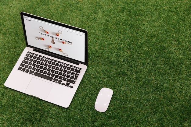 Laptop mockup on grass