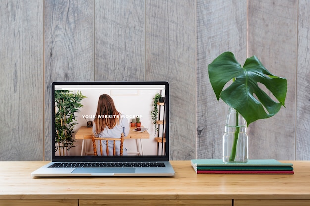 PSD laptop mockup on table with plants