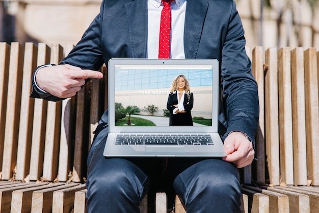 PSD laptop mockup with businessman