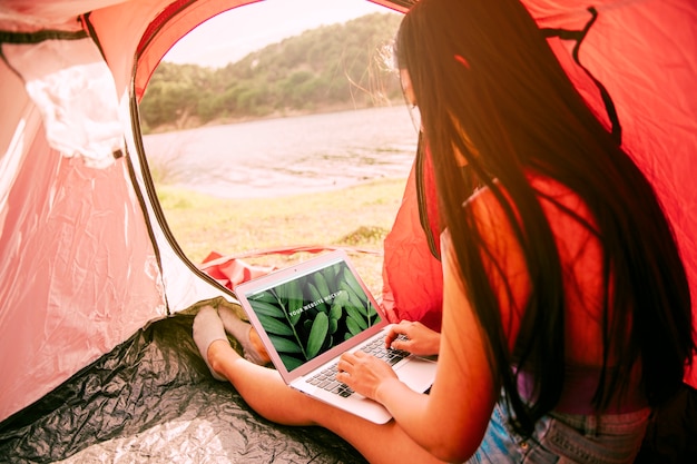 Laptop mockup with camping in nature concept