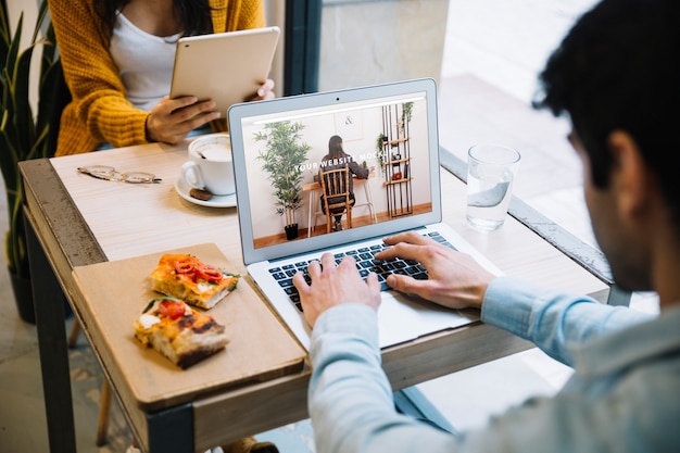 Laptop mockup with couple working