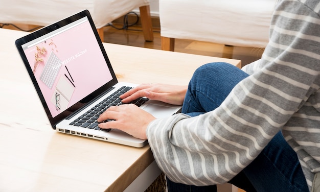 PSD laptop mockup with woman working at home