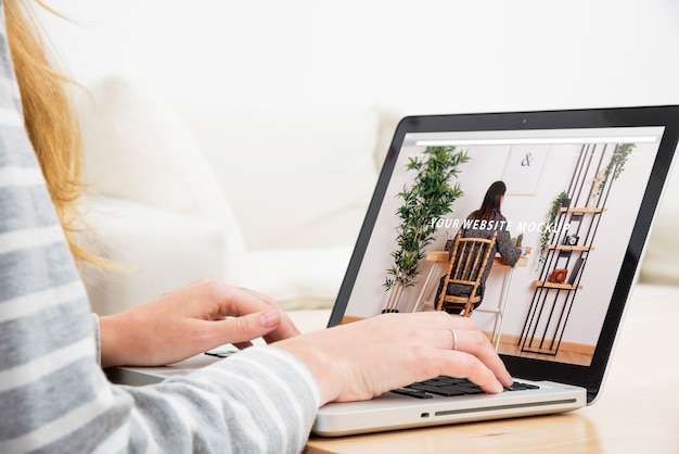 PSD laptop mockup with woman working at home