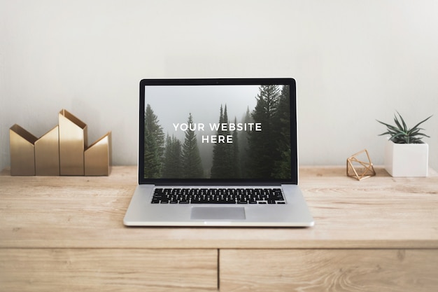 PSD laptop mockup on wooden desk