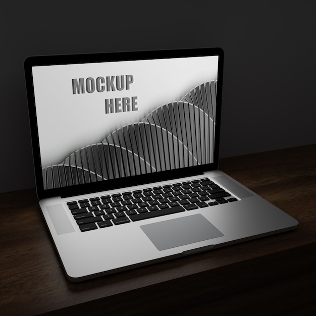 laptop screen mockup in the dark on wooden desk