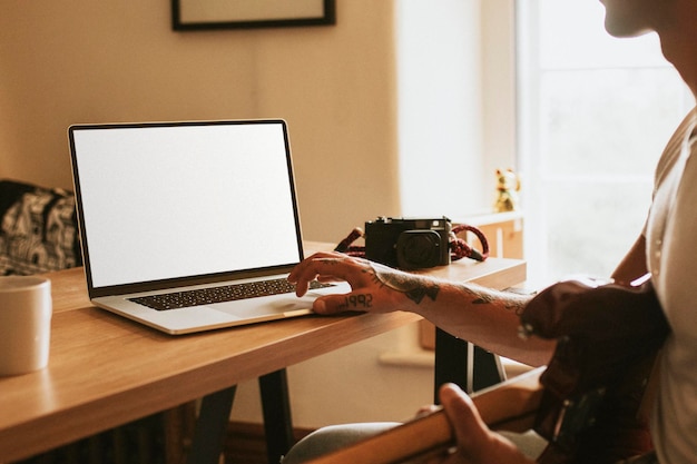 Laptop screen mockup and man working remotely