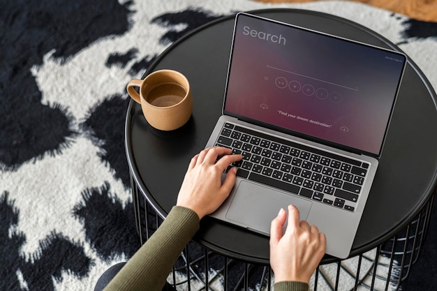 PSD laptop screen mockup psd with a woman hand typing on the keyboard