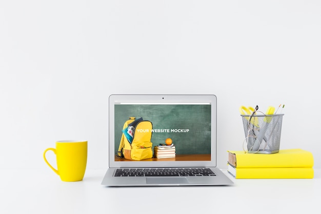 Laptop with mockup screen in clean and tidy workspace. education theme