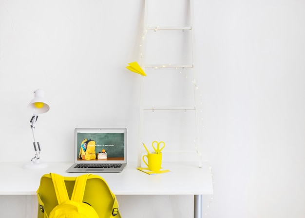 Laptop with mockup screen in clean and tidy workspace. education theme